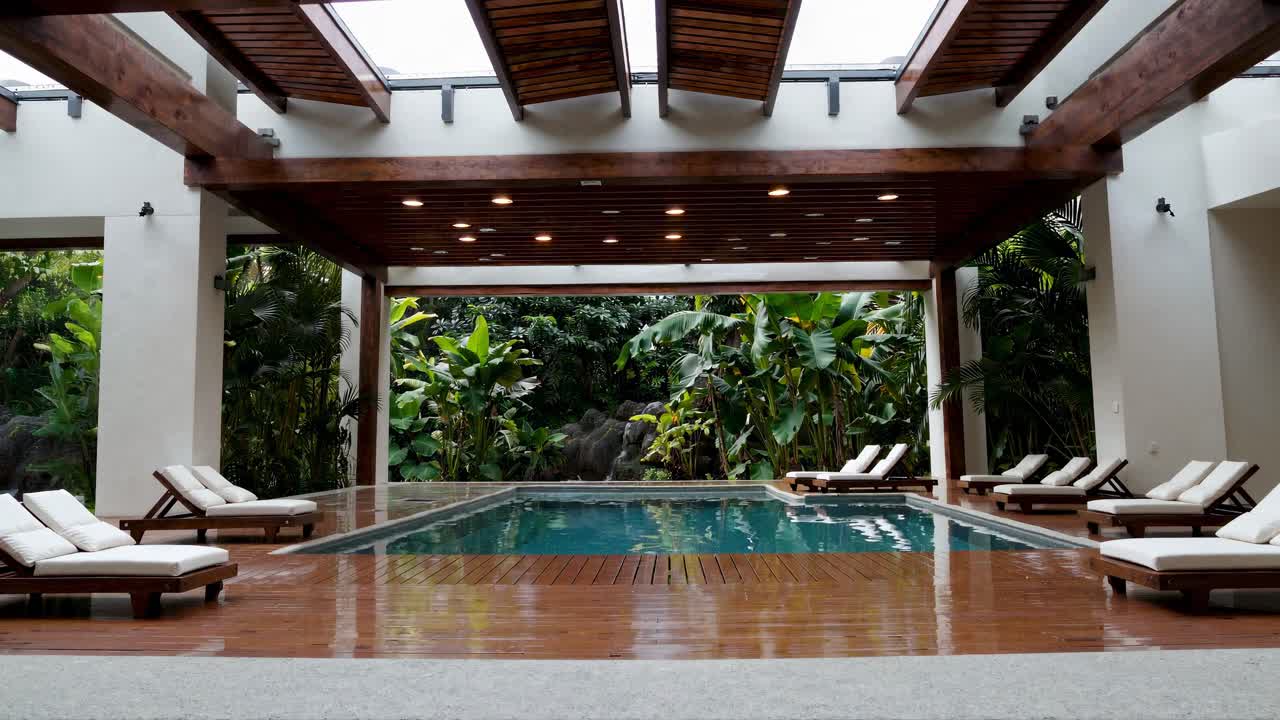 Luxury Indoor Outdoor Swimming Pool with Tropical Garden View