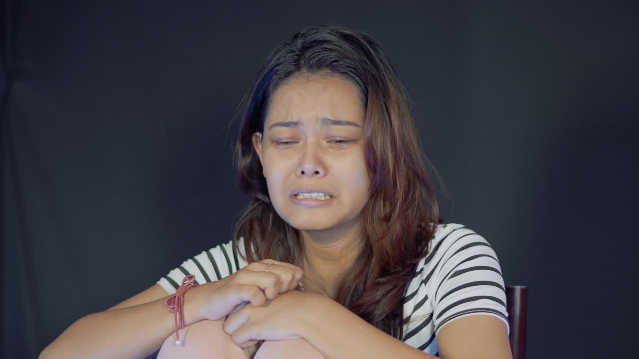 Teenage north east indian girl crying with deep depression alone, closeup