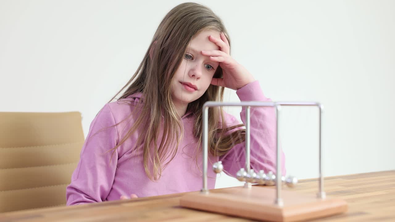 Girl with Newton's Cradle