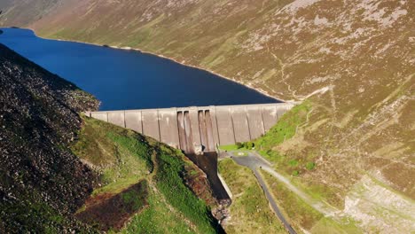 orbiting aerial view of ben crom reservoir nestled in the mourne mountains of northern ireland