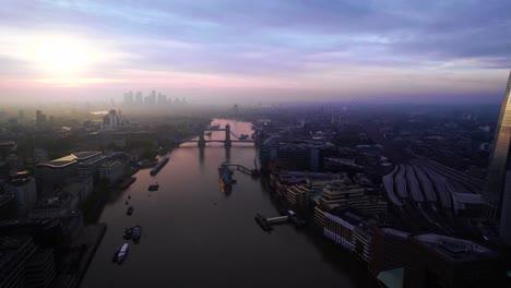 aerial stunning london skyline with purple pink sunset skies over river thames