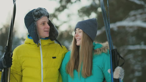 Loving-guy-and-girl-skiing-in-winter-forest-in-slow-motion-smiling-and-looking-at-each-other