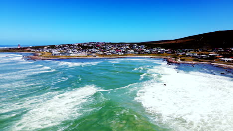 High-angle-view-over-bay-showing-coastal-village-of-Cape-Agulhas,-South-Africa