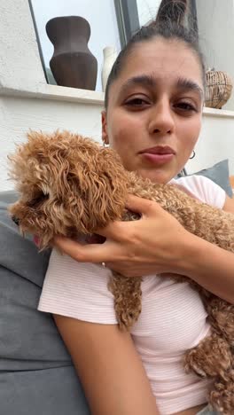 una mujer abrazando a un caniche.