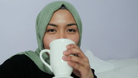 female student listening intently whilst looking directly toward camera