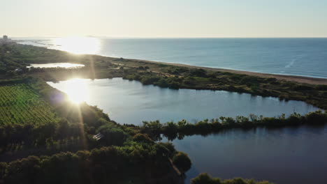 hermosa puesta de sol sobre viñedos estanque frente a la playa el mar mediterráneo aérea