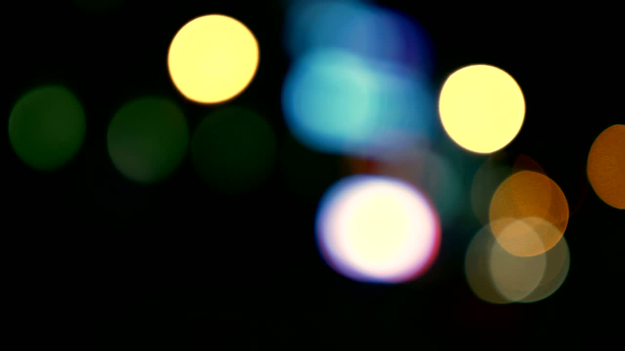 Defocused lights Los Angeles street abstract . City blur background. Moving bokeh circles of night traffic.