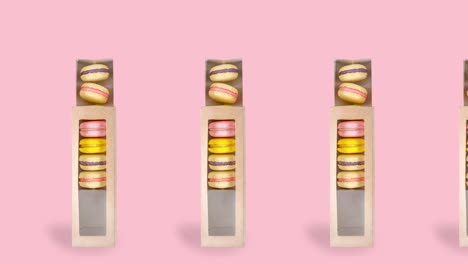 muchos macarrones redondos brillantes en una caja animada sobre un fondo rosado. galletas sabrosas moviéndose de izquierda a derecha, 4k