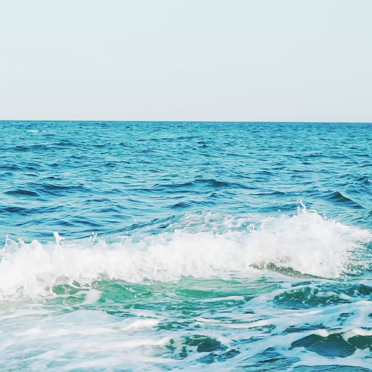 rough sea on the background of clear sky. Slow motion. Sea waves. Aerial view