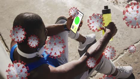 Animation-of-man-holding-smartphone-with-covid-19-vaccination-passport-over-coronavirus-cells