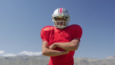 american football player standing with arms crossed