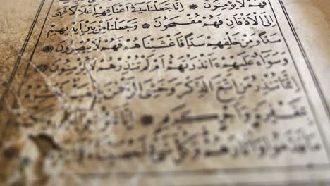 footage of an old quran, the shot is moving from the top to the bottom