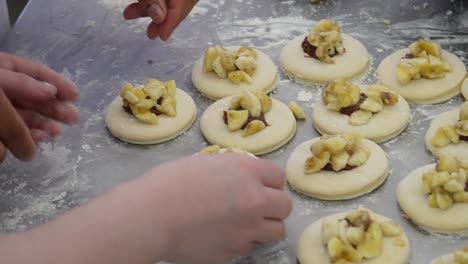 step into the pastry shop: close-up shot captures a hand meticulously crafting sweet treats with care and precision