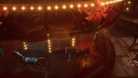 a vintage carousel with horses stands empty in a dimly lit room.