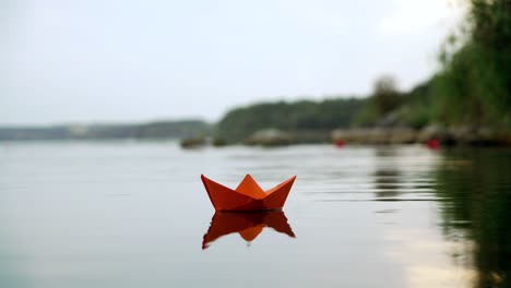 papieren boot die op de rivier drijft. origami.