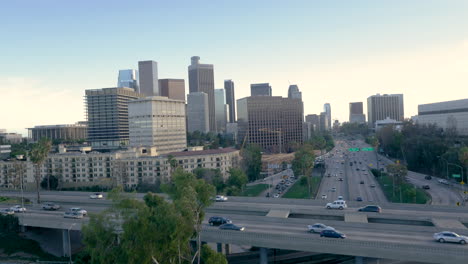 aerial view of busy multi-level freeway and city skyline