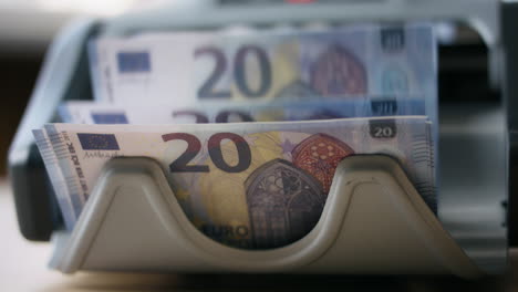 closeup counter counting banknotes european currency. bank equipment for cash.