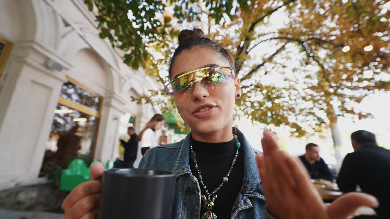 Young woman enjoying coffee outdoors