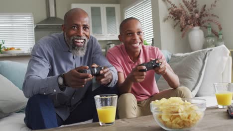 video of happy african american father and son playing video games