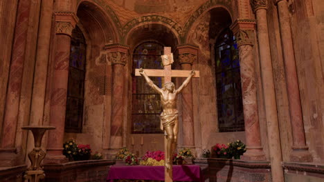 a golden crucifix stands in saint-nicolas church, blois, france, with warm light