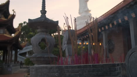 incense sticks at a vietnamese temple at sunset