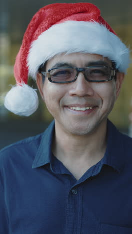 smiling man wearing santa hat