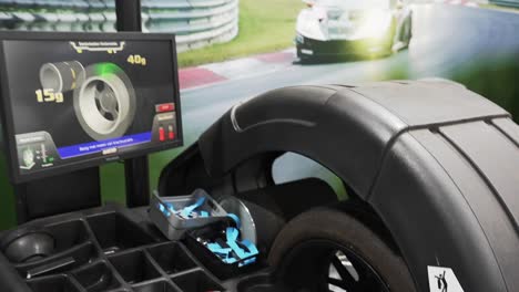 a close-up shows a tire being precisely measured by an aligning machine in a well-equipped garage