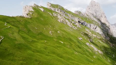 Secede-mountain-peak-and-green-vibrant-slope,-aerial-drone-view