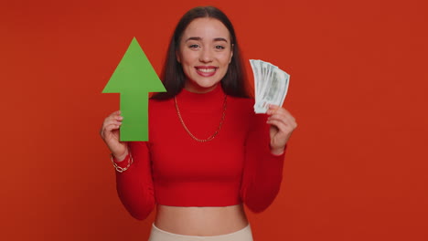 woman holding green arrow and money smiling