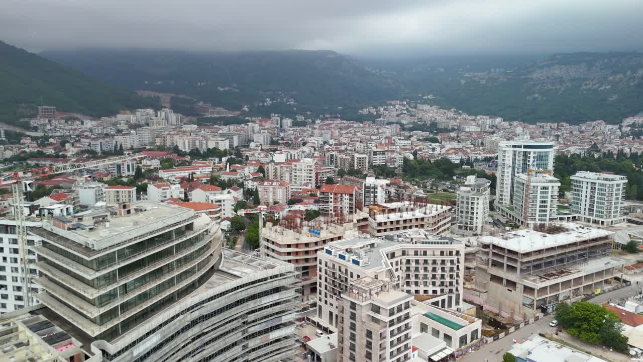 Flyover waterfront buildings in Budva Montenegro on overcast day
