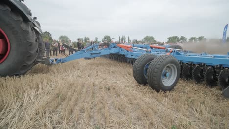 demonstration of agricultural machinery at an exhibition. tractors operate in the field, showcasing their capabilities and performance in action