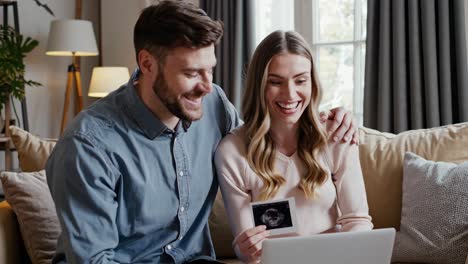 happy couple looking at ultrasound scan