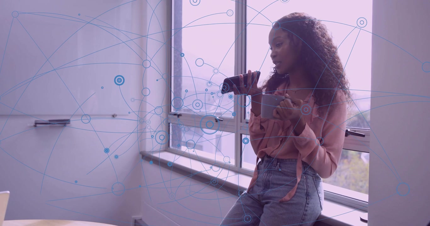 Woman leaning by window raising phone and speaking for tech briefing while network nodes radiating