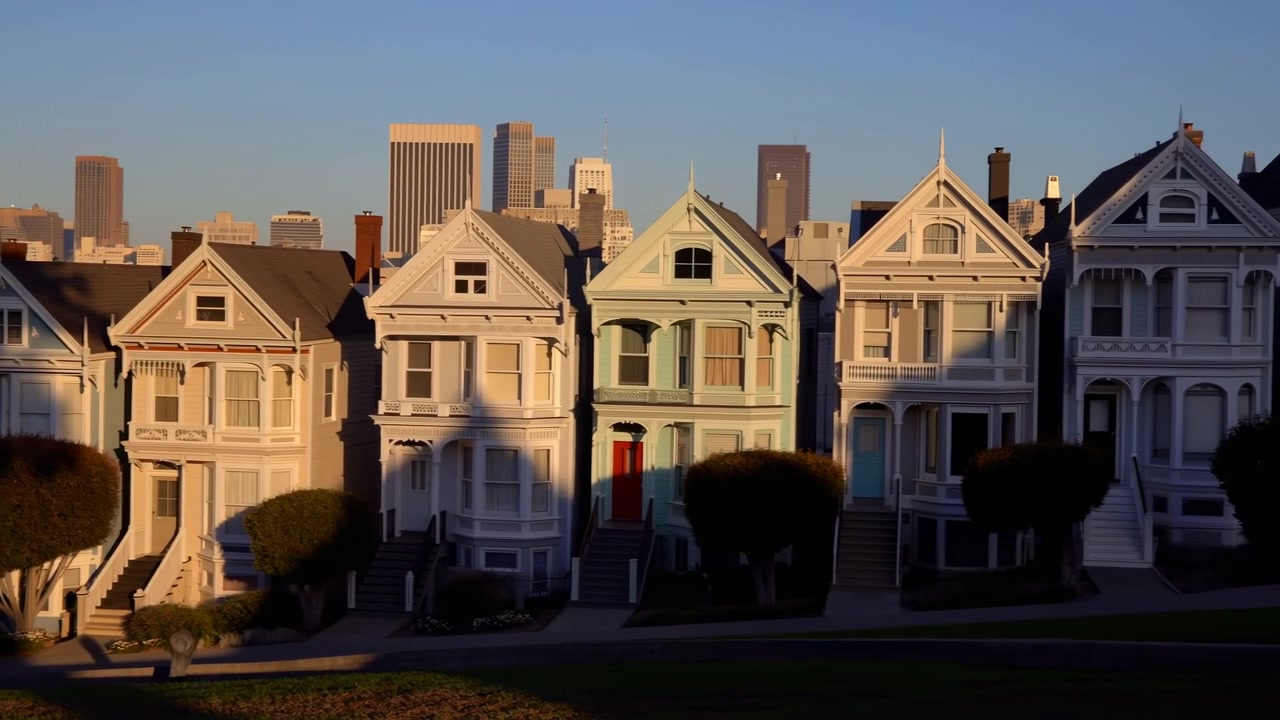 Sunset Victorian Row Houses With Skyline, Golden Hour Light Casts Long Shadows Across Pastel Facades, Ornate