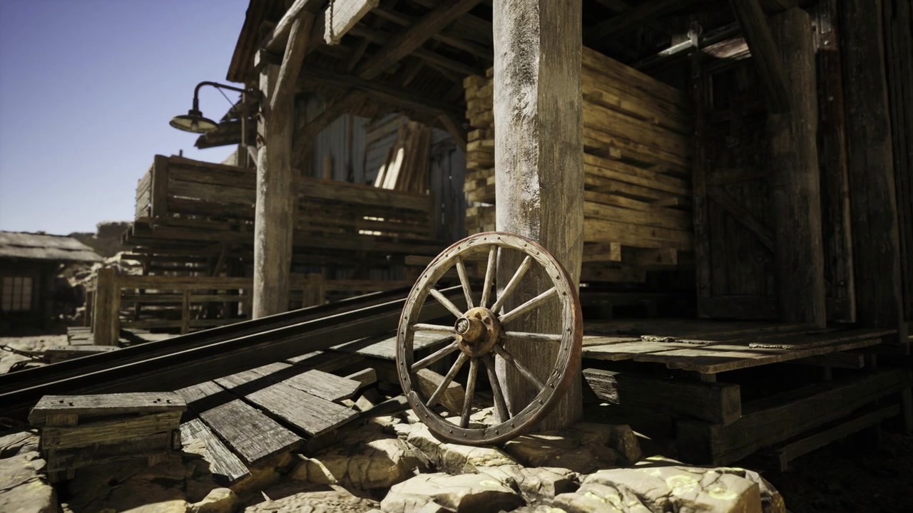 Historisk westernscene med vognhjul og ældgamle saloon-indgangsskilte