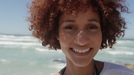 Woman-looking-at-camera-on-the-beach-4k