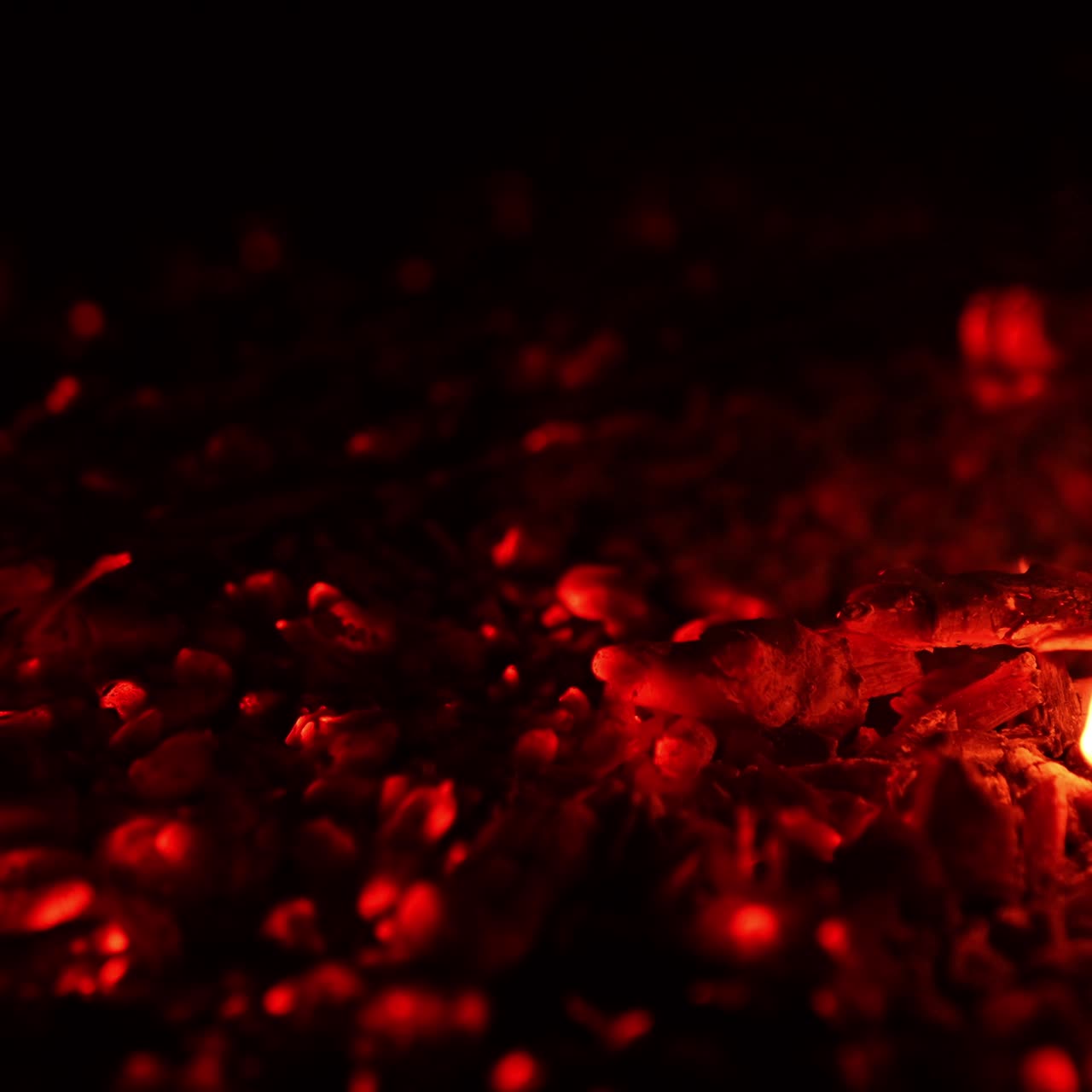 Fireplace explosion slow motion. Red heat on black background