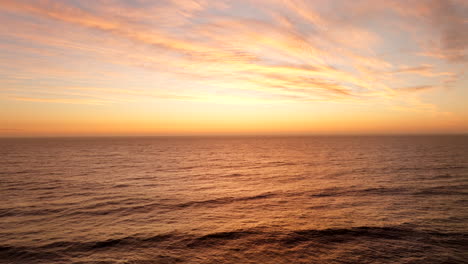 slow motion sunset aerial scenery, dramatic skies, idyllic ocean water