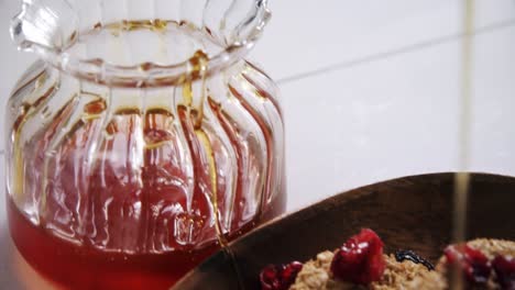 honey pouring into a cereal bowl 4k