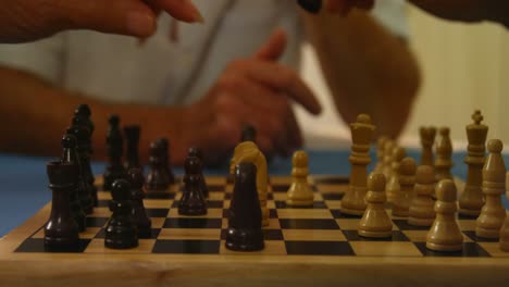 close-up of hands playing chess