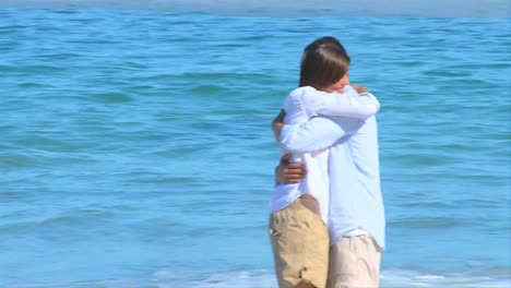 cute couple hugging on a beach