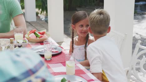 happy family eating together at table