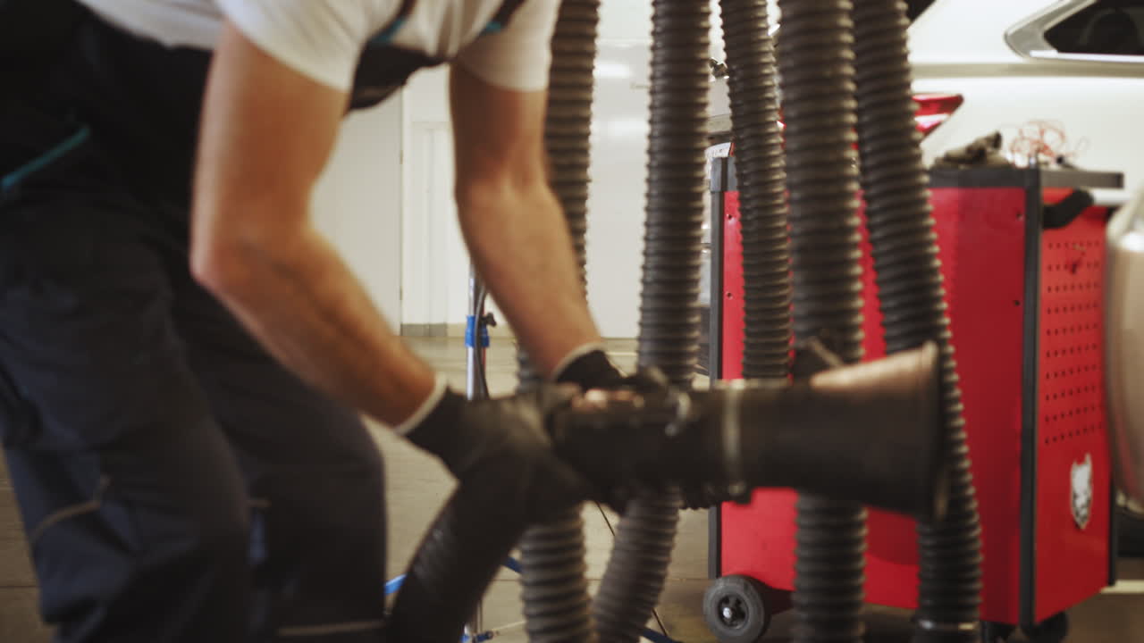 Mechanic Cleaning Exhaust System of a Car