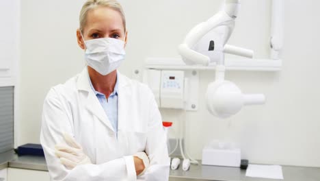 Female-dentist-standing-with-arms-crossed