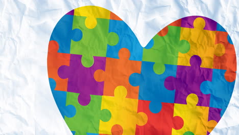 animación del corazón en el mes de concienciación del autismo rompecabezas sobre papel arrugado