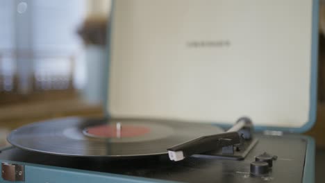 persona tocando un disco de vinilo en un tocadiscos retro
