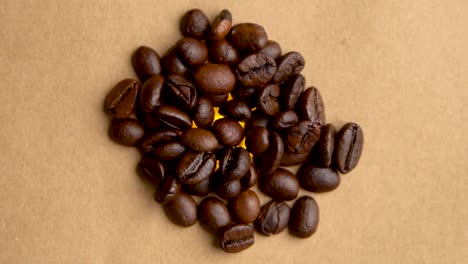 pile of coffee beans rotates in a circle close up filming from above