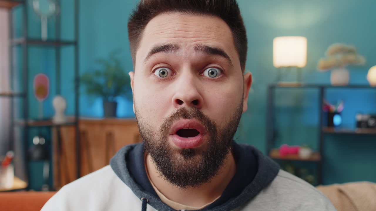 Excited caucasian man surprised shocked by sudden victory good win news celebrating wow reaction