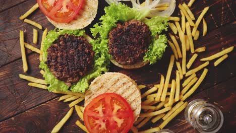 two tasty grilled home made burgers with beef  tomato  onion and lettuce