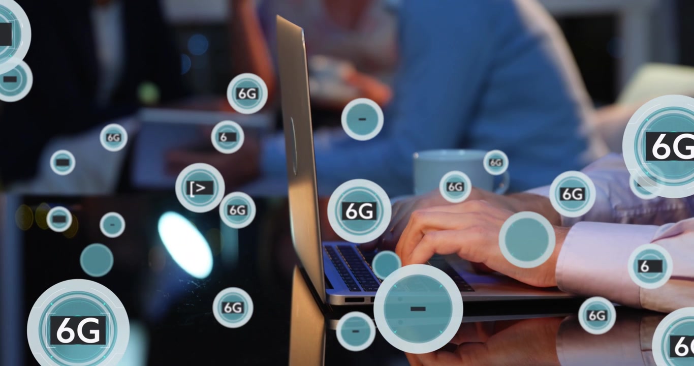 Animation of 6g text and symbols in circles over cropped hands of caucasian man working on laptop